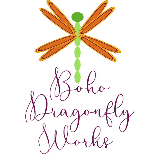 Cartoon dragonfly logo with four orange wings and a green body. The Business name Boho Dragonfly Works.